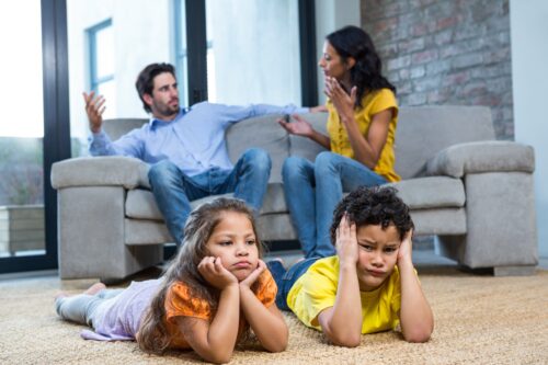 Children laying on the carpet in living room